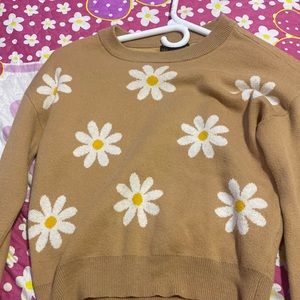 This shirt is tan color white yellow flowers The shirt is in good condition